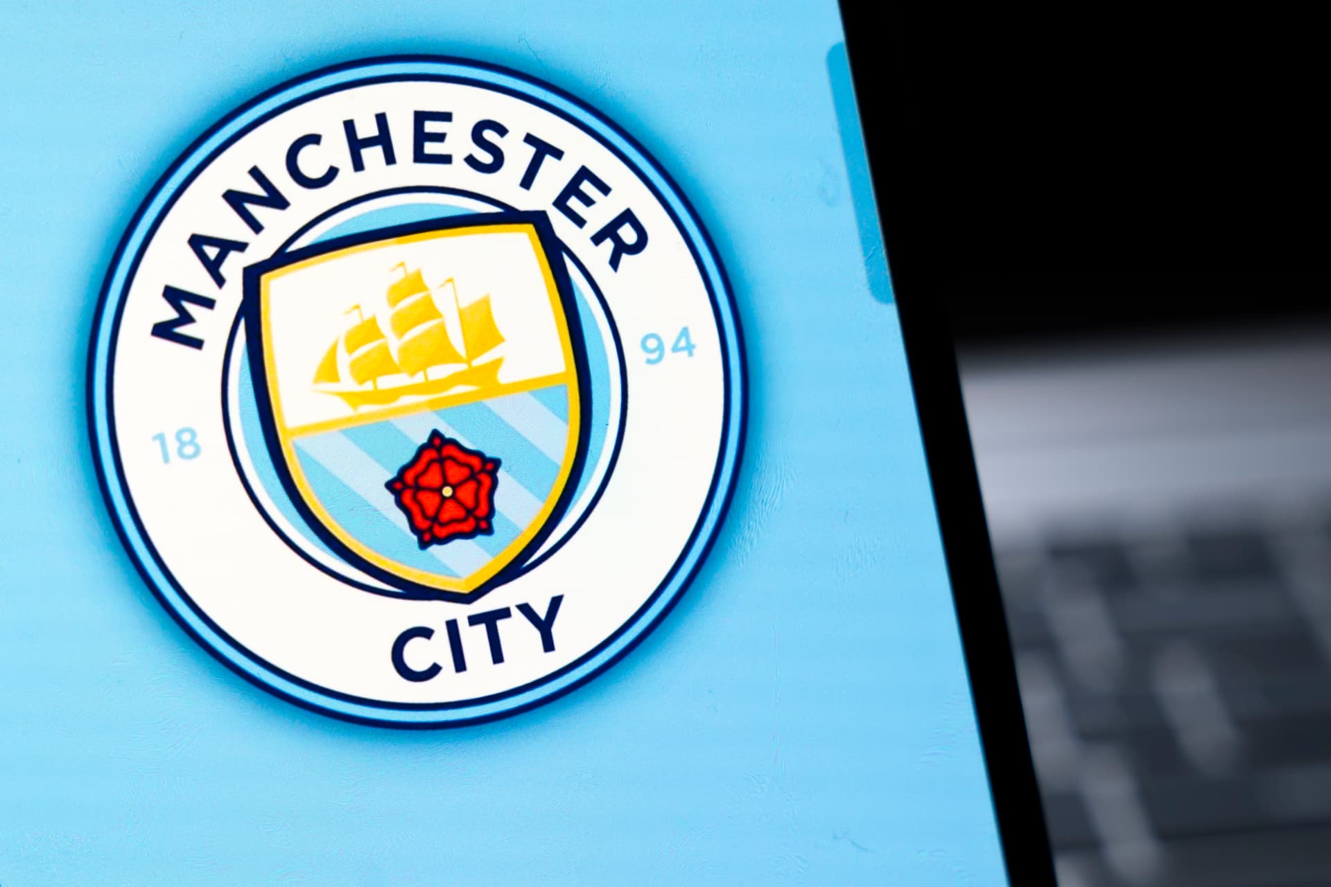 Manchester City crest shown on a screen